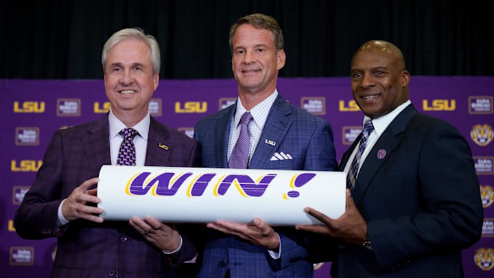 Dec 1, 2025; Baton Rouge, LA, USA; LSU president Wade Rousse, left, LSU new head coach Lane Kiffin and LSU athletic director Verge Ausberry stand together at South Stadium Club at Tiger Stadium. Mandatory Credit: Matthew Hinton-Imagn Images