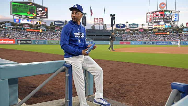 Apr 10, 2026; Los Angeles, California, USA; Los Angeles Dodgers shortstop Mookie Betts (50) looks on from the dugout steps during the game against the Texas Rangers at Dodger Stadium. Mandatory Credit: Jayne Kamin-Oncea-Imagn Images