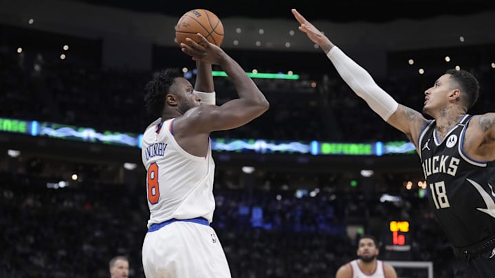 Mar 28, 2025; Milwaukee, Wisconsin, USA; New York Knicks forward OG Anunoby (8) puts up a shot against Milwaukee Bucks forward Kyle Kuzma (18) in the second half at Fiserv Forum. Mandatory Credit: Michael McLoone-Imagn Images