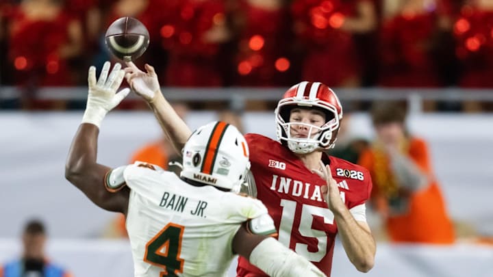 Jan 19, 2026; Miami Gardens, FL, USA; Miami Hurricanes defensive lineman Rueben Bain Jr. (4) defends against Indiana Hoosiers quarterback Fernando Mendoza (15) during the College Football Playoff National Championship game at Hard Rock Stadium. Mandatory Credit: Mark J. Rebilas-Imagn Images