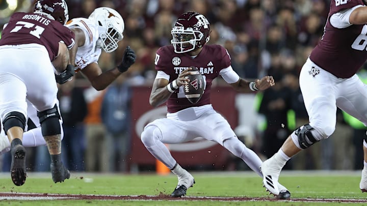 Nov 30, 2024; College Station, Texas, USA; Texas A&M Aggies quarterback Marcel Reed (10) scrambles with the ball during the first quarter against the Texas Longhorns at Kyle Field. 