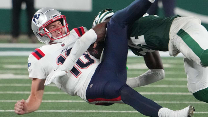 Sep 19, 2024; East Rutherford, New Jersey, USA; New England Patriots quarterback Drake Maye (10)  gets sacked hard by New York Jets linebacker Jamien Sherwood (44) in the 4th quarter at MetLife Stadium. Mandatory Credit: Robert Deutsch-Imagn Images
