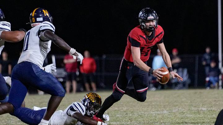 Naples Golden Eagles defensive back Tariq Arbyummi (3) dives and sacks Port Charlotte Pirates quarterback Logan Flaherty (17) during the fourth quarter of the Class 4A Region 3 championship at Port Charlotte High School in Port Charlotte, Fla., on Friday, Nov. 29, 2024.