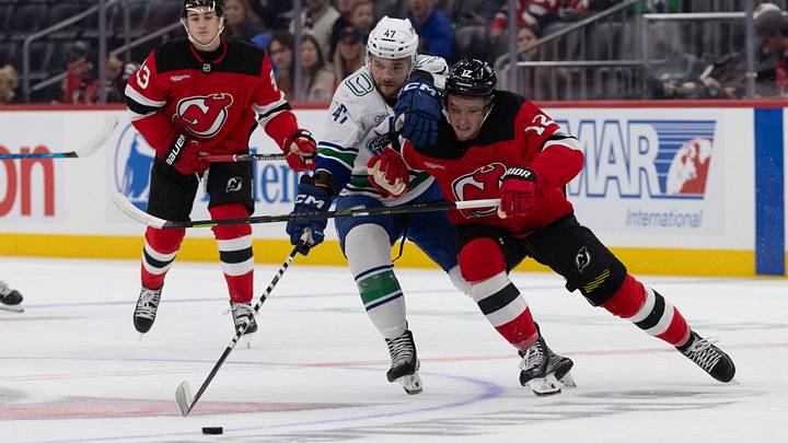 Oct 10, 2026; Newark, New Jersey, USA; Vancouver Canucks left wing Paul Cotter (47) and New Jersey Devils center Cody Glass (12) go after the puck during the first period at Prudential Center. Mandatory Credit: Thomas Salus-Imagn Images Oct 10, 2026; Newark, New Jersey, USA; Vancouver Canucks left wing Paul Cotter (47) and New Jersey Devils center Cody Glass (12) go after the puck during the first period at Prudential Center. Mandatory Credit: Thomas Salus-Imagn Images