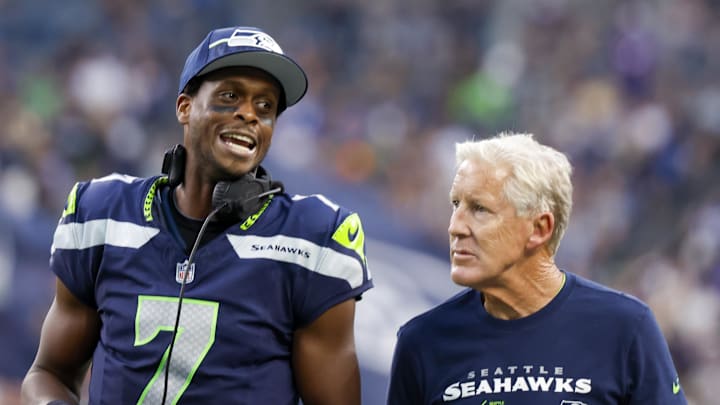 Seattle Seahawks quarterback Geno Smith (7) talks with head coach Pete Carroll during the second quarter against the Dallas Cowboys at Lumen Field.