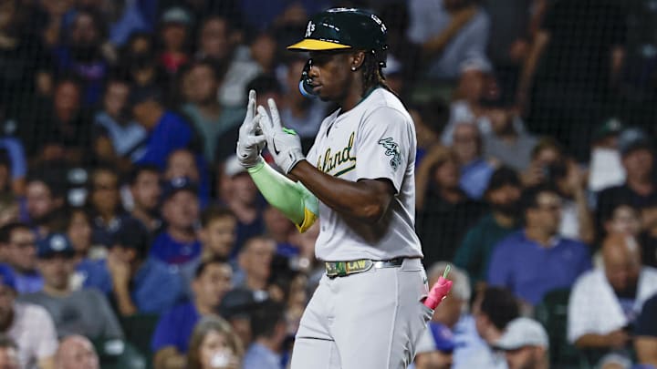 Sep 17, 2024; Chicago, Illinois, USA; Oakland Athletics outfielder Lawrence Butler (4) celebrates as he crosses home plate after hitting a solo home run against the Chicago Cubs during the third inning at Wrigley Field. Mandatory Credit: Kamil Krzaczynski-Imagn Images