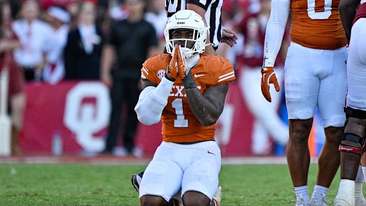 Texas Longhorns defensive end Colin Simmons (1) kneels on the field after the Longhorns stop the Oklahoma Sooners during the second half at the Cotton Bowl.