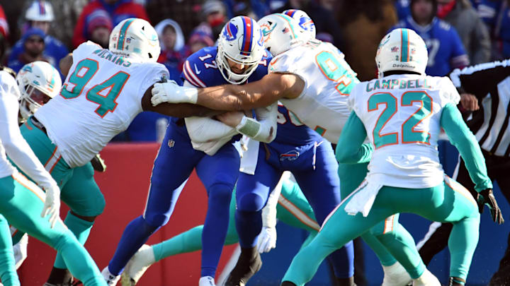 Buffalo Bills quarterback Josh Allen (17) is hit by Miami Dolphins defensive tackle Christian Wilkins (94) and defensive tackle Zach Sieler (92) during the first half in a NFL wild card game at Highmark Stadium in the 2022 playoffs. Buffalo Bills quarterback Josh Allen (17) is hit by Miami Dolphins defensive tackle Christian Wilkins (94) and defensive tackle Zach Sieler (92) during the first half in a NFL wild card game at Highmark Stadium in the 2022 playoffs.