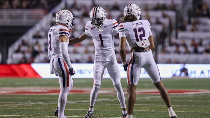 Sep 28, 2024; Salt Lake City, Utah, USA; Arizona Wildcats defensive back Gunner Maldonado (9), defensive back Tacario Davis (1) and defensive back Genesis Smith (12) celebrate a stop on fourth down against the Utah Utes during the first quarter at Rice-Eccles Stadium. Mandatory Credit: Rob Gray-Imagn Images