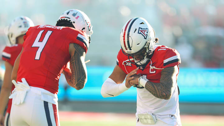 Oct 26, 2024; Tucson, Arizona, USA; Arizona Wildcats quarterback Noah Fifita (11) does handshake with Arizona Wildcats wide receiver Tetairoa McMillan (4) before the game against West Virginia Mountaineers at Arizona Stadium.