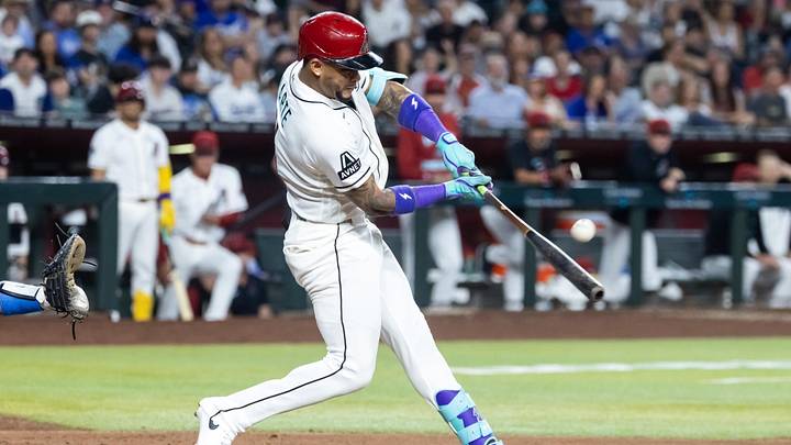Jun 2, 2026; Phoenix, Arizona, USA; Arizona Diamondbacks second baseman Ketel Marte hits a sacrifice fly to drive in a run in the fifth inning against the Los Angeles Dodgers at Chase Field. Mandatory Credit: Mark J. Rebilas-Imagn Images