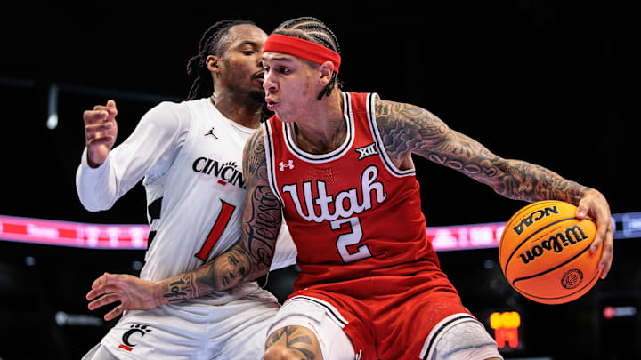 Mar 10, 2026; Kansas City, MO, USA; Utah Utes guard Terrence Brown (2) drives around Cincinnati Bearcats guard Day Day Thomas (1) during the second half at T-Mobile Center. Mandatory Credit: William Purnell-Imagn Images Mar 10, 2026; Kansas City, MO, USA; Utah Utes guard Terrence Brown (2) drives around Cincinnati Bearcats guard Day Day Thomas (1) during the second half at T-Mobile Center. Mandatory Credit: William Purnell-Imagn Images