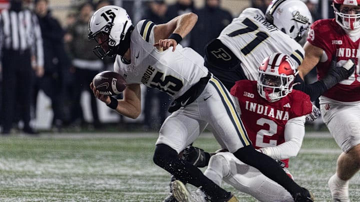 Purdue Boilermakers quarterback Ryan Browne (15) runs the ball while Indiana Hoosiers linebacker Jailin Walker (2) defends Purdue Boilermakers quarterback Ryan Browne (15) runs the ball while Indiana Hoosiers linebacker Jailin Walker (2) defends