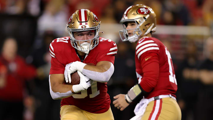 Dec 30, 2024; Santa Clara, California, USA; San Francisco 49ers running back Isaac Guerendo (31) runs with the ball during the first quarter against the Detroit Lions at Levi's Stadium. Mandatory Credit: Sergio Estrada-Imagn Images Dec 30, 2024; Santa Clara, California, USA; San Francisco 49ers running back Isaac Guerendo (31) runs with the ball during the first quarter against the Detroit Lions at Levi's Stadium. Mandatory Credit: Sergio Estrada-Imagn Images
