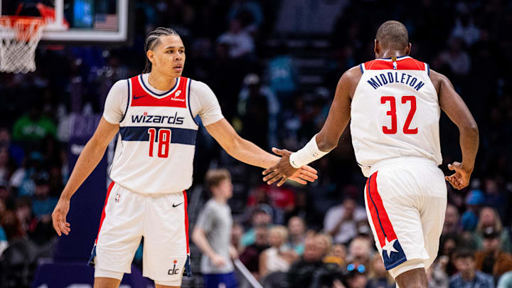 Mar 1, 2025; Charlotte, North Carolina, USA; Washington Wizards forward Kyshawn George (18) celebrates with forward Khris Middleton (32) during the third quarter against the Charlotte Hornets at Spectrum Center. Mandatory Credit: Scott Kinser-Imagn Images