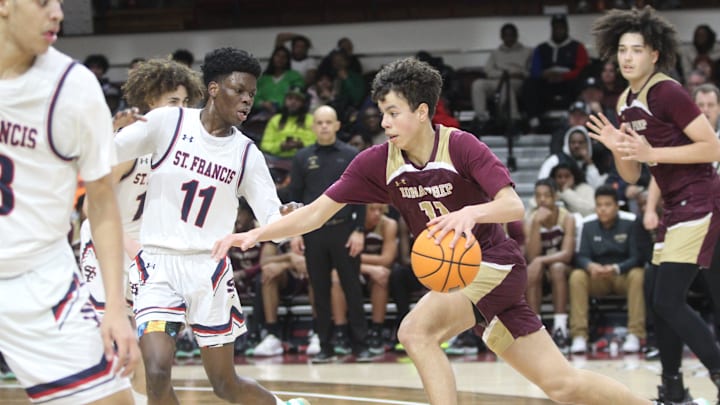 Iona Prep's Lucas Morillo (11, red) tries to drive past St. Francis Prep's Nigel Moore (11, white) during the CHSAA AA city quarterfinals at Fordham University on March 5, 2023.

Img 1710
