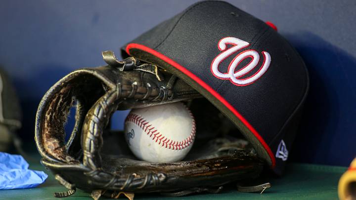 Dark blue Washington Nationals hat on top of a black mitt Dark blue Washington Nationals hat on top of a black mitt