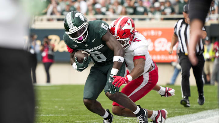 Sep 13, 2025; East Lansing, Michigan, USA; Youngstown State linebacker Carston Marshall (5) tackles Michigan State wide receiver Nick Marsh (6) in the second quarter at Spartan Stadium. Mandatory Credit: Brendan Mullin-Imagn Images