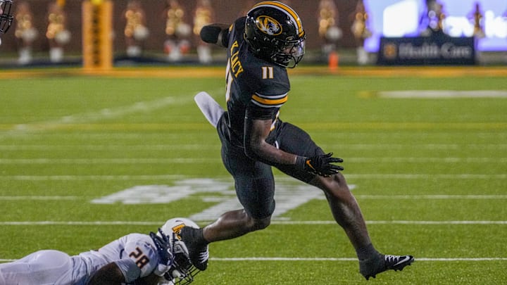 Aug 29, 2024; Columbia, Missouri, USA; Missouri Tigers running back Kewan Lacy (11) runs the ball as Murray State Racers defensive back Esteban Guillory (28) attempts the tackle during the second half at Faurot Field at Memorial Stadium. Mandatory Credit: Denny Medley-Imagn Images