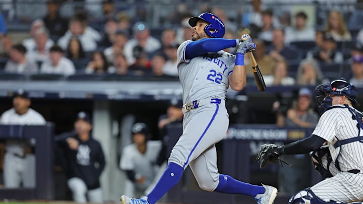 Oct 5, 2024; Bronx, New York, USA; Kansas City Royals outfielder Tommy Pham (22) hits an RBI sacrifice fly during the second inning against the New York Yankees during game one of the ALDS for the 2024 MLB Playoffs at Yankee Stadium. Mandatory Credit: Brad Penner-Imagn Images