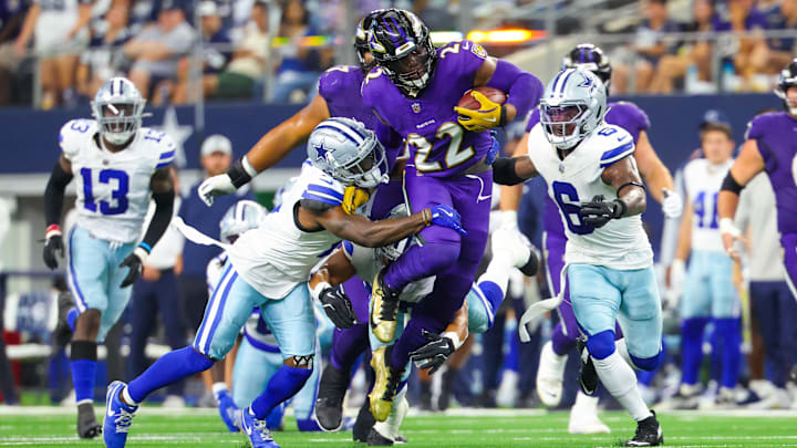 Sep 22, 2024; Arlington, Texas, USA; Baltimore Ravens running back Derrick Henry (22) runs during the first half as Dallas Cowboys safety Donovan Wilson (6) and Dallas Cowboys cornerback Jourdan Lewis (2) defend at AT&T Stadium. Mandatory Credit: Kevin Jairaj-Imagn Images