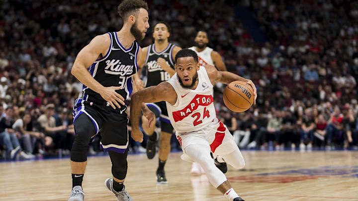 Oct 8, 2023; Vancouver, British Columbia, CAN; Toronto Raptors guard Markquis Nowell (24) drives against Sacramento Kings guard Jordan Ford (31) in the second half at Rogers Arena. Raptors won 112-99. 