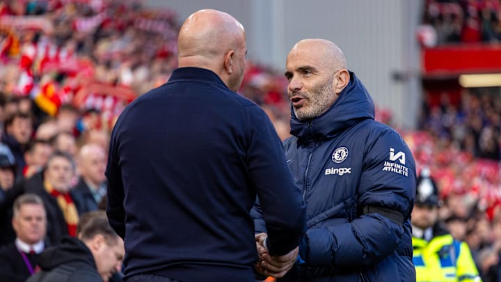 Slot (left) and Maresca (right) shaking hands before Liverpool vs Chelsea at Anfield.