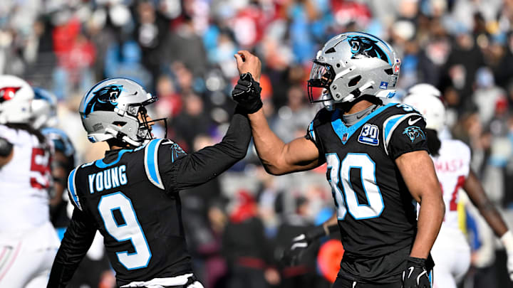Dec 22, 2024; Charlotte, North Carolina, USA;  Carolina Panthers running back Chuba Hubbard (30) celebrates with quarterback Bryce Young (9) after scoring a touchdown in the first quarter at Bank of America Stadium. Mandatory Credit: Bob Donnan-Imagn Images