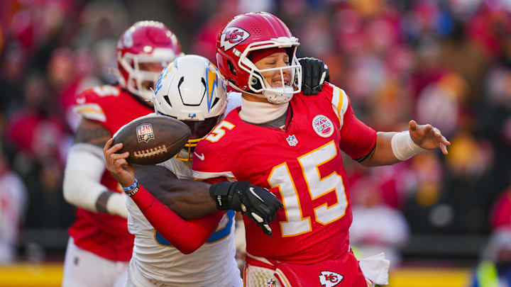 Dec 14, 2025; Kansas City, Missouri, USA; Kansas City Chiefs quarterback Patrick Mahomes (15) is sacked by Los Angeles Chargers linebacker Odafe Oweh (98) during the second half at GEHA Field at Arrowhead Stadium. Mandatory Credit: Jay Biggerstaff-Imagn Images