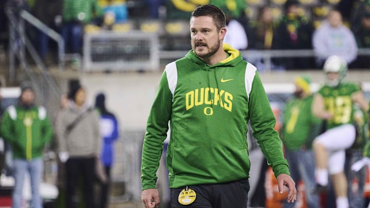 Nov 19, 2022; Eugene, Oregon, USA; Oregon Ducks head coach Dan Lanning watches players warm up before a game against the Utah Utes at Autzen Stadium. Mandatory Credit: Troy Wayrynen-Imagn Images