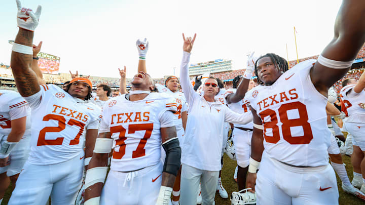 Texas Longhorns head coach Steve Sarkisian and defensive back Wardell Mack celebrate with the team after a win over the Oklahoma Sooners. Texas Longhorns head coach Steve Sarkisian and defensive back Wardell Mack celebrate with the team after a win over the Oklahoma Sooners.