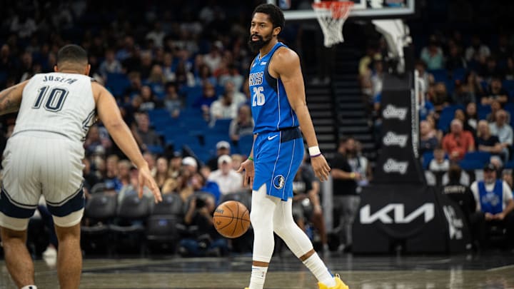 Mar 27, 2025; Orlando, Florida, USA; Dallas Mavericks guard Spencer Dinwiddie (26) dribbles the ball against Orlando Magic guard Cory Joseph (10) in the first quarter at Kia Center. Mandatory Credit: Jeremy Reper-Imagn Images