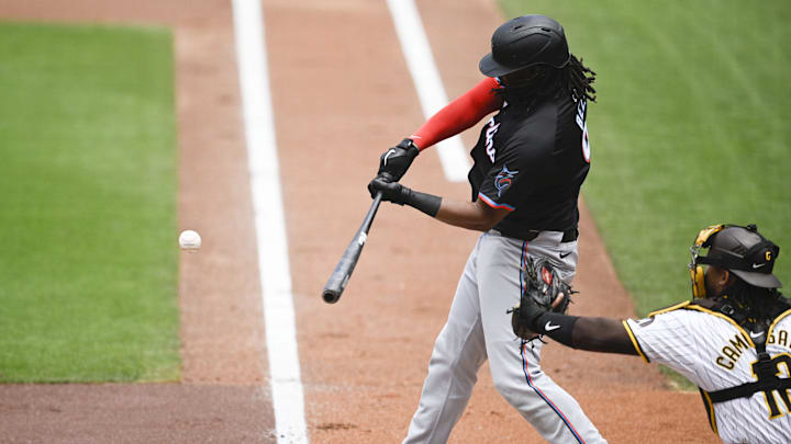May 29, 2024; San Diego, California, USA; Miami Marlins first baseman Josh Bell (9) hits a single during the first inning against the San Diego Padres at Petco Park.