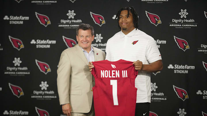 Cardinals defensive lineman Walter Nolen stands and holds his jersey with owner Michael Bidwill (left) during his introductory news conference inside the Arizona Cardinals training facility on April 25, 2025, in Tempe.