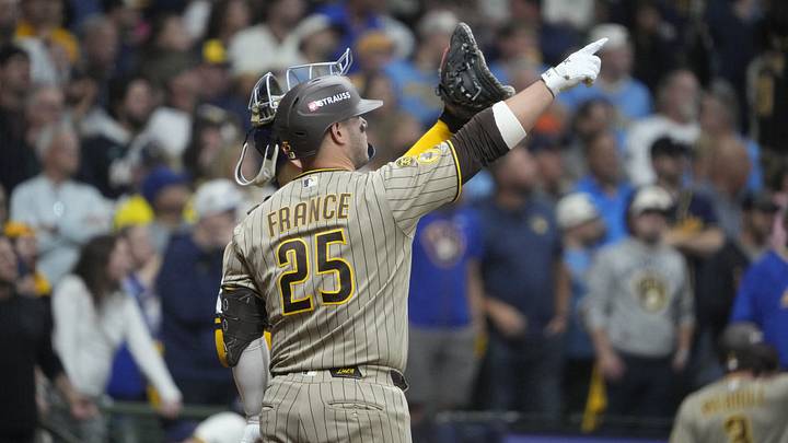 Oct 3, 2026; Milwaukee, Wisconsin, USA; San Diego Padres first baseman Ty France (25) discusses a play where the ball may have hit a wire on the top of the dome of the stadium during the ninth inning against the Milwaukee Brewers in game one of the NLDS for the 2026 MLB Playoffs at American Family Field. Mandatory Credit: Michael McLoone-Imagn Images Oct 3, 2026; Milwaukee, Wisconsin, USA; San Diego Padres first baseman Ty France (25) discusses a play where the ball may have hit a wire on the top of the dome of the stadium during the ninth inning against the Milwaukee Brewers in game one of the NLDS for the 2026 MLB Playoffs at American Family Field. Mandatory Credit: Michael McLoone-Imagn Images