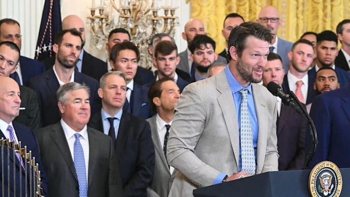 US President Donald Trump (R) looks on as pitcher Clayton Kershaw speaks during an event honoring the 2024 World Series champions Los Angeles Dodgers in the East Room of the White House in Washington, DC, on April 7, 2025.