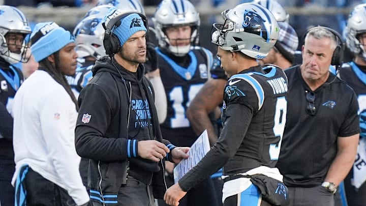 Dec 22, 2024; Charlotte, North Carolina, USA; Carolina Panthers head coach Dave Canales talks with quarterback Bryce Young (9) during a time out during the second half against the Arizona Cardinals at Bank of America Stadium.