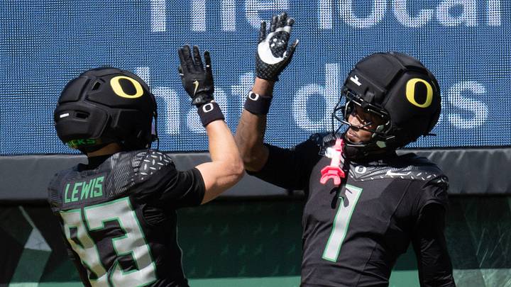 Oregon’s Hudson Lewis, and Dakorien Moore celebrate a fourth-quarter touchdown for Combat Ducks during the Oregon Spring Game at Autzen Stadium in Eugene April 25, 2026