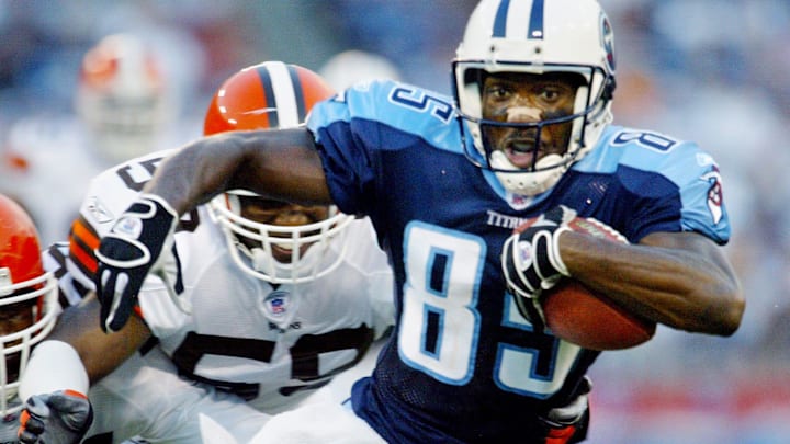 No. 8-Derrick Mason: Tennessee Titans receiver Mason (85) tries to evade Cleveland Browns defender Kevin Bentley during the first quarter of a preseason game at the Coliseum Aug. 9, 2003.

Titans V Browns