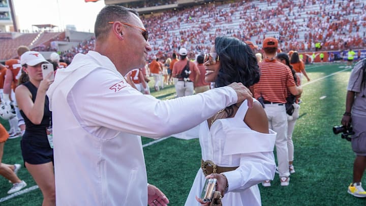 Texas Longhorns head coach Steve Sarkisian hugs and kisses his wife Loreal Sarkisian after the NCAA college football game.