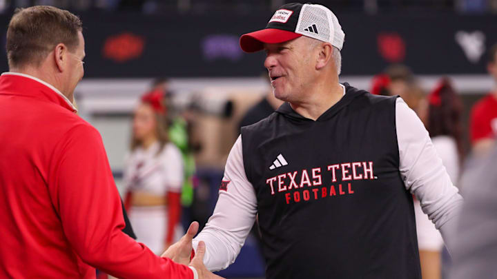 Texas Tech head coach Joey McGuire shakes hands with director of athletics Kirby Hocutt before the Big 12 Conference championship football game, Saturday, Nov. 6, 2025, at AT&T Stadium in Arlington.