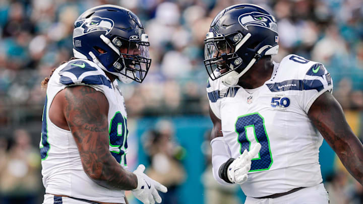 Oct 12, 2025; Jacksonville, Florida, USA; Seattle Seahawks defensive end Leonard Williams (99) and linebacker DeMarcus Lawrence (0) celebrate after a play against the Jacksonville Jaguars at EverBank Stadium.