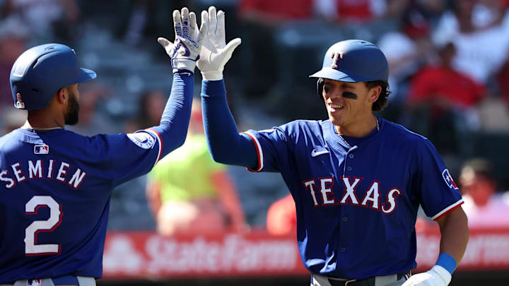 Sep 29, 2024; Anaheim, California, USA;  Texas Rangers designated hitter Dustin Harris (38) celebrates with second baseman Marcus Semien (2) after hitting a home run, his first MLB home run, during the ninth inning against the Los Angeles Angels at Angel Stadium. 