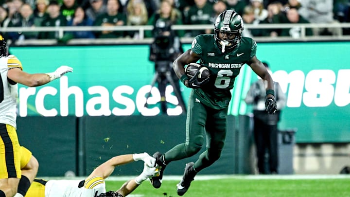 Michigan State's Nick Marsh, right, breaks a tackle attempt by Iowa's John Nestor during the third quarter on Saturday, Oct. 19, 2024, at Spartan Stadium in East Lansing.