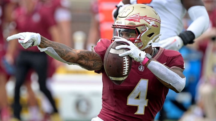 Oct 14, 2023; Tallahassee, Florida, USA; Florida State Seminoles wide receiver Keon Coleman (4) celebrates after catching a pass over Syracuse Orange defensive back Jason Simmons Jr. (6) (not pictured) during the first quarter at Doak S. Campbell Stadium. Mandatory Credit: Melina Myers-USA TODAY Sports Oct 14, 2023; Tallahassee, Florida, USA; Florida State Seminoles wide receiver Keon Coleman (4) celebrates after catching a pass over Syracuse Orange defensive back Jason Simmons Jr. (6) (not pictured) during the first quarter at Doak S. Campbell Stadium. Mandatory Credit: Melina Myers-USA TODAY Sports