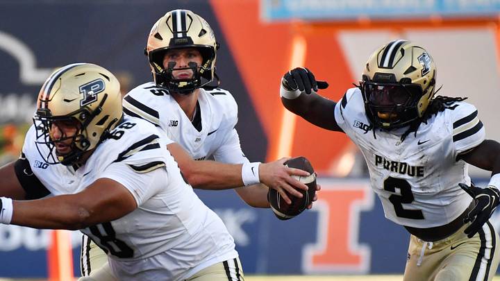 Purdue Boilermakers quarterback Ryan Browne (15) fakes a handoff to running back Fame Ijeboi (2). Purdue Boilermakers quarterback Ryan Browne (15) fakes a handoff to running back Fame Ijeboi (2).
