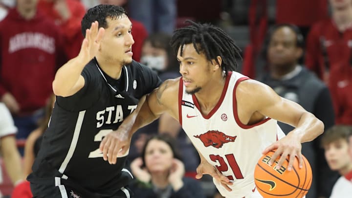 Mar 8, 2025; Fayetteville, Arkansas, USA; Arkansas Razorbacks guard D.J. Wagner (21) drives against Mississippi State Bulldogs forward RJ Melendez (22) during the second half at Bud Walton Arena. Arkansas won 93-92. 