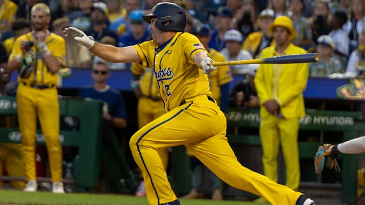 Longtime Pittsburgh Pirates shortstop Jack Wilson (2) embraces Savannah Bananas infielder Ryan Cox (6) in his guest appearance during the Texas Tailgaters and Savannah Bananas game Saturday, Aug. 30, 2025 at PNC Park in Pittsburgh, Pa.