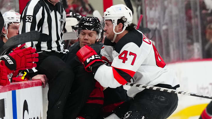 Paul Cotter (Devils forward #47) checking Taylor Hall (Hurricanes forward #71) in game two of the first round of the 2025 Stanley Cup Playoffs. 