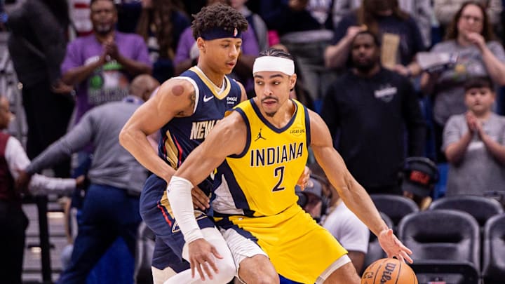Dec 20, 2025; New Orleans, Louisiana, USA;  Indiana Pacers guard/forward Andrew Nembhard (2) dribbles against New Orleans Pelicans guard Jeremiah Fears (0) during the first half at Smoothie King Center. Mandatory Credit: Stephen Lew-Imagn Images
